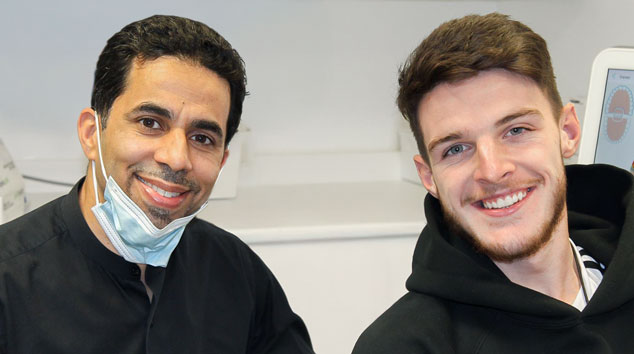 Dr Sadiq with Declan Rice: Dr Kalim Sadiq with Arsenal and England footballer Declan Rice at Orchard Orthodontics Croydon during his Invisalign treatment